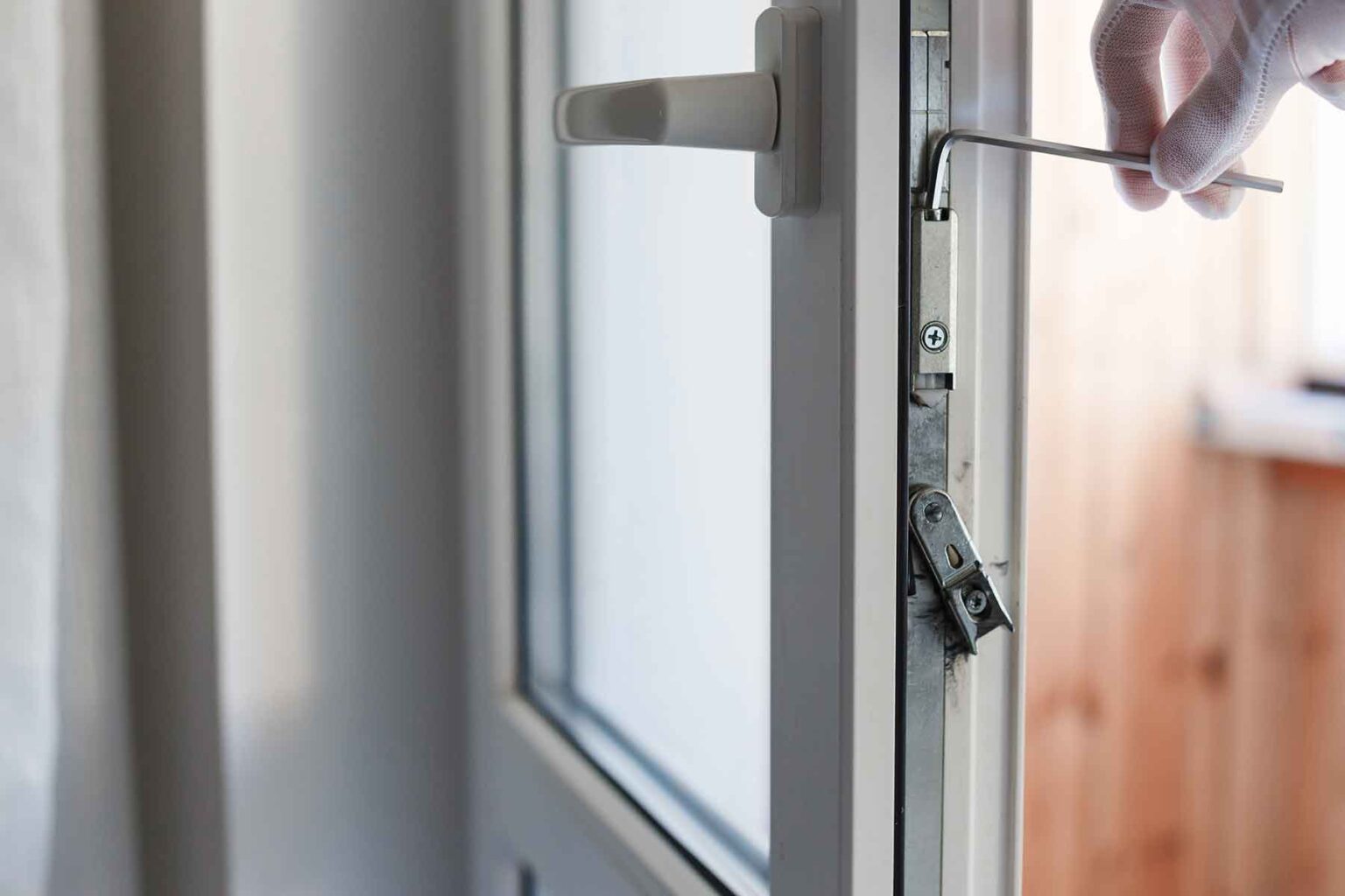 mans-hand-makes-adjustment-of-hardware-of-the-upvc-Q9TE3ZY.jpg